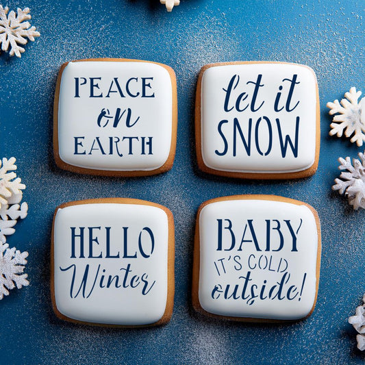 Winter-themed cookies decorated with stencils: 'Hello Winter,' 'Let it Snow,' 'Peace on Earth,' and 'Baby it's Cold Outside!.'