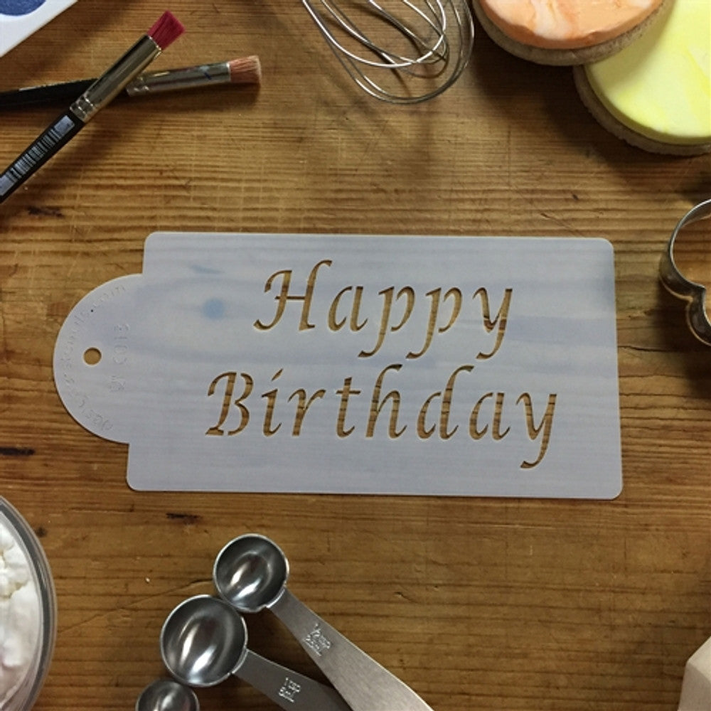 Happy Birthday cake stencil on wooden table with cake decorating tools, ideal for festive baking and decoration.