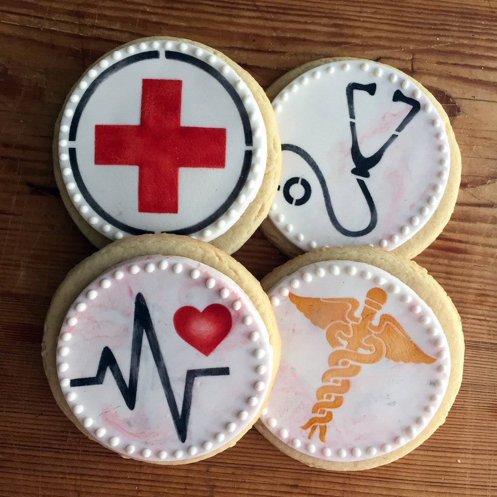 Medical symbols cookie designs featuring red cross, stethoscope, heart rate line, and caduceus.