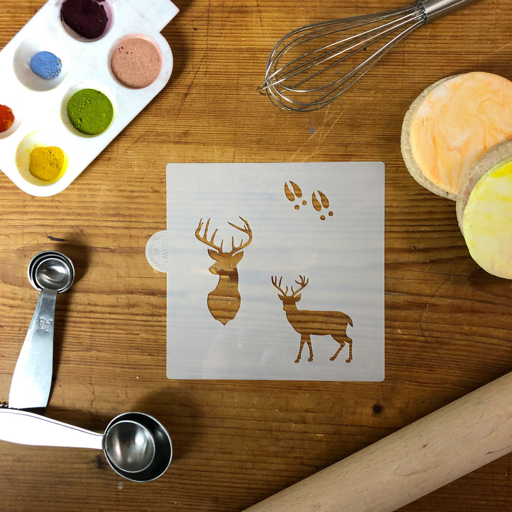 Deer buck cookie stencil on a wooden table with paints and baking tools for DIY crafts.
