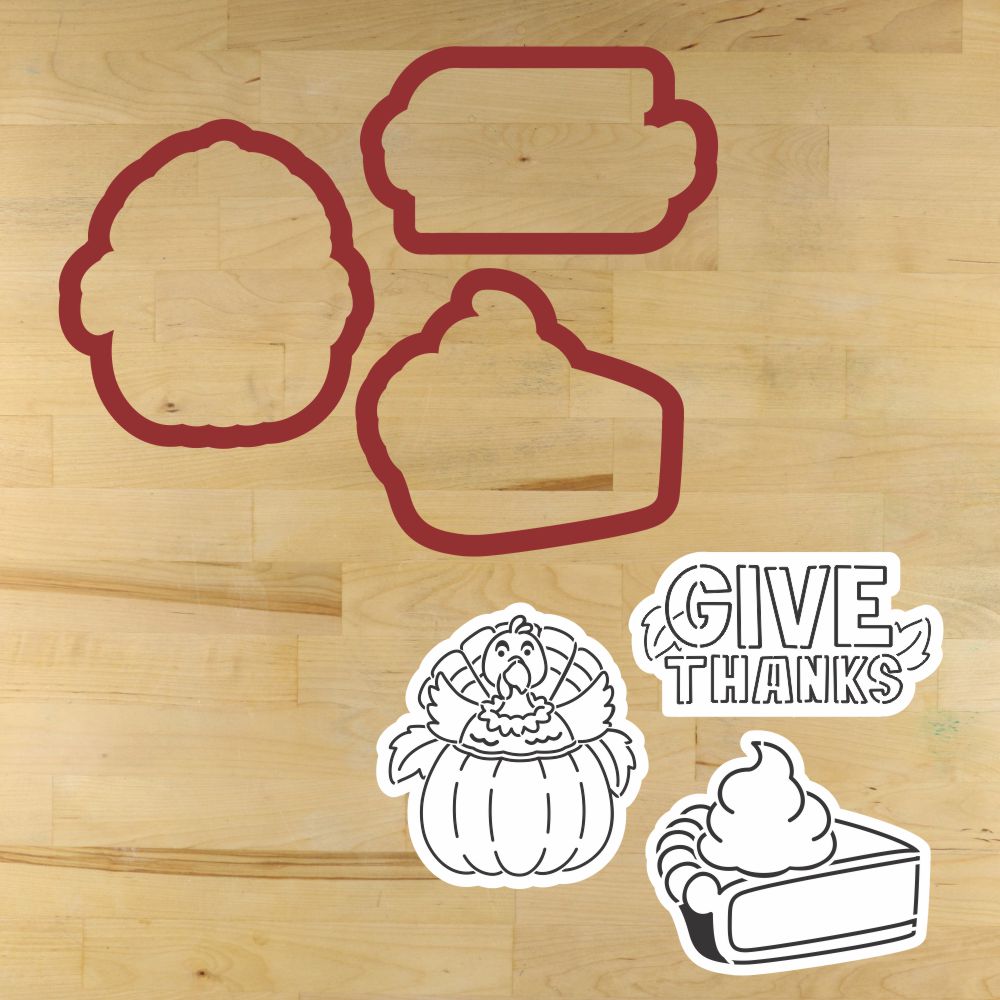 Set of cookie cutters with Thanksgiving designs on a wooden surface