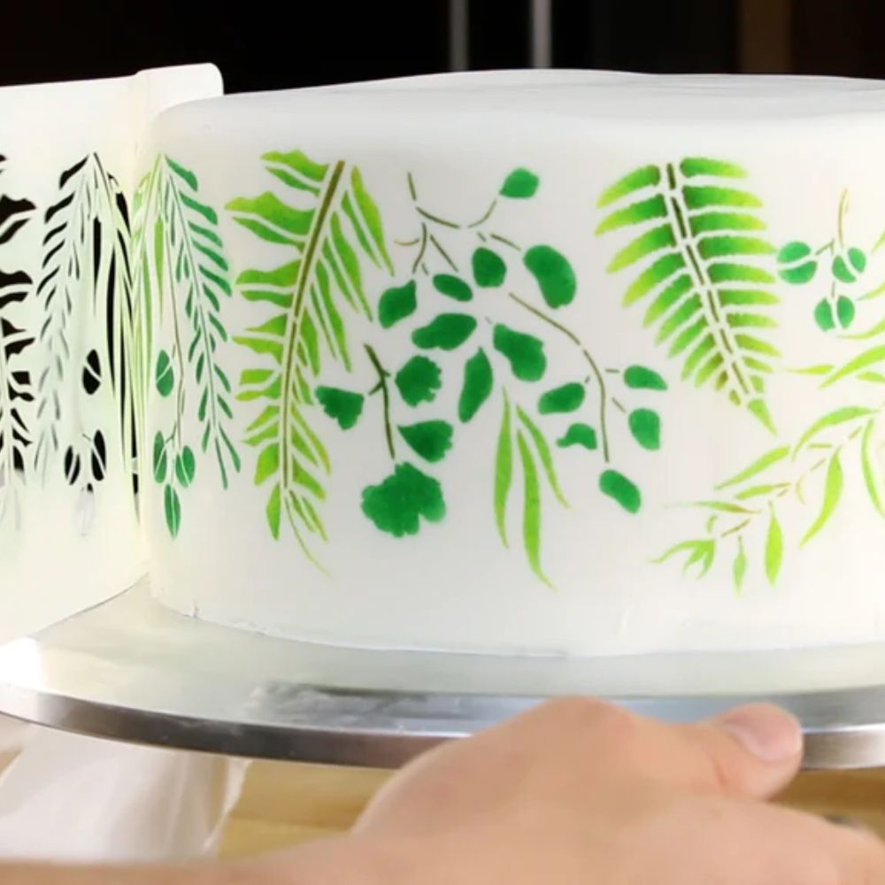 Airbrushing a cake with cake stencils.