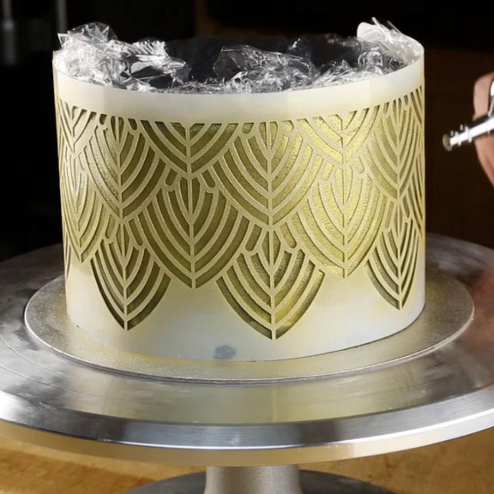 Airbrushing a cake with cake stencils