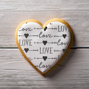 Heart shaped cookie decorated using the Love and Arrows Basic Background Cookie Stencil
