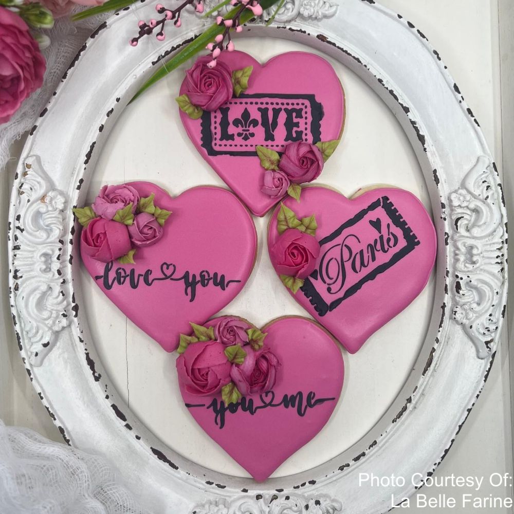 Heart shaped cookies decorated using the Love Script Cookie Stencil