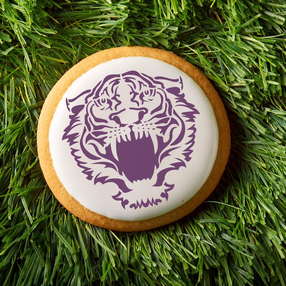 Tiger front view mascot cookie with purple icing on a grassy background, perfect for team spirit and celebrations.