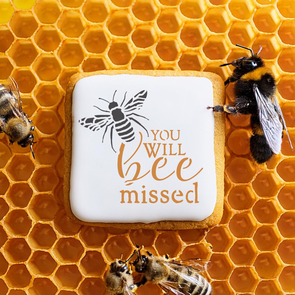 You Will Bee Missed cookie stencil design on a cookie surrounded by bees and honeycomb.