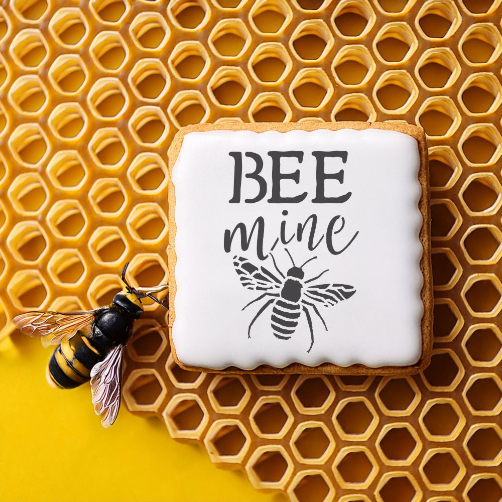 Bee Mine Valentine's Day cookie stencil on honeycomb background with bee decoration.