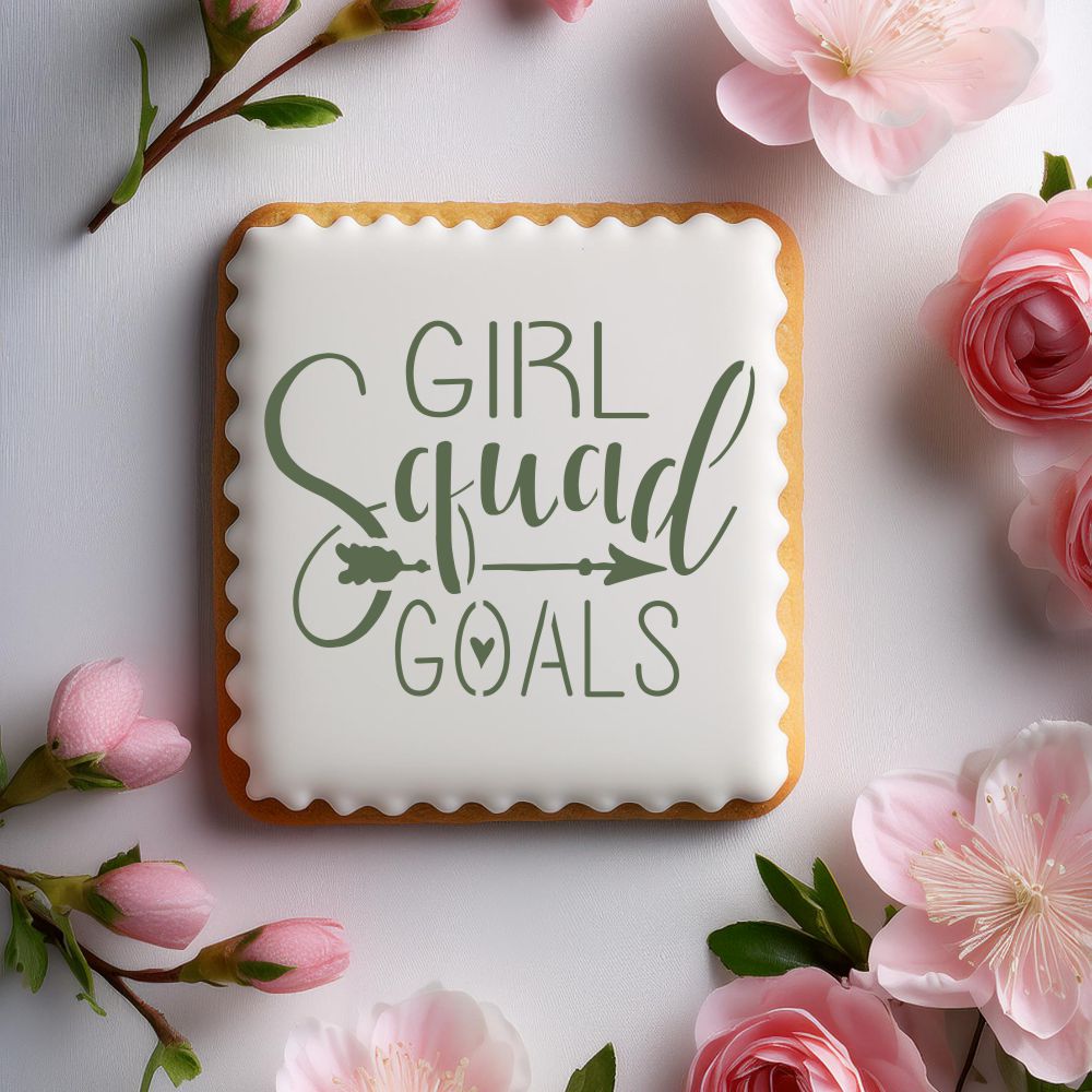 Cookie decorated with 'Girl Squad Goals' stencil surrounded by pink flowers, perfect for celebrations.