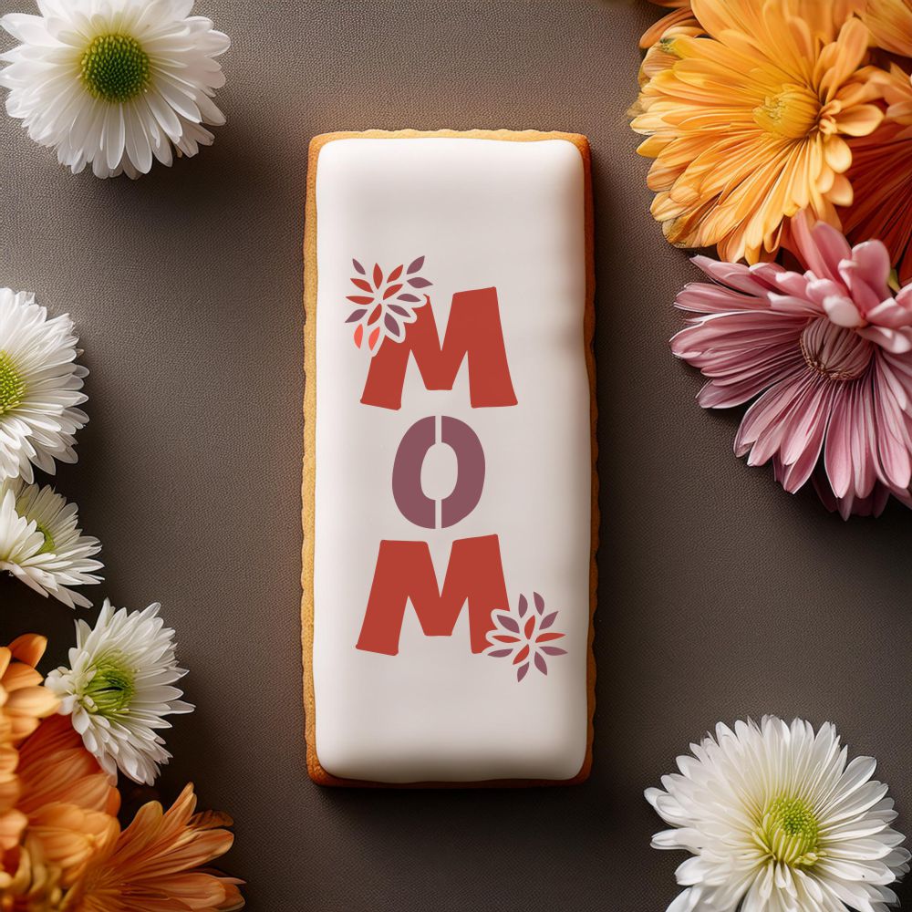 Chrysanthemum Mom cookie stencil design on decorated cookie surrounded by flowers.