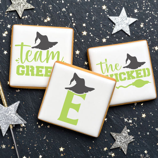 Cookies decorated with Team Green and Wicked designs, featuring witch hats, perfect for themed parties.