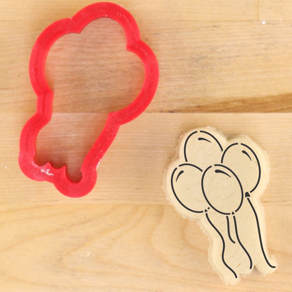 Balloon shaped cookie cutter next to a mockup of the balloon stencil imprinted on cookie dough.