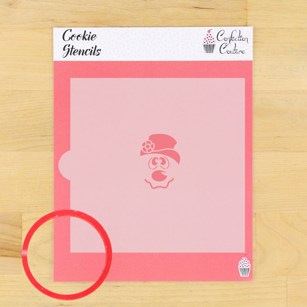 Frosty Snowman cookie stencil on a pink background with a round red cutter, ideal for holiday cookie decorating.