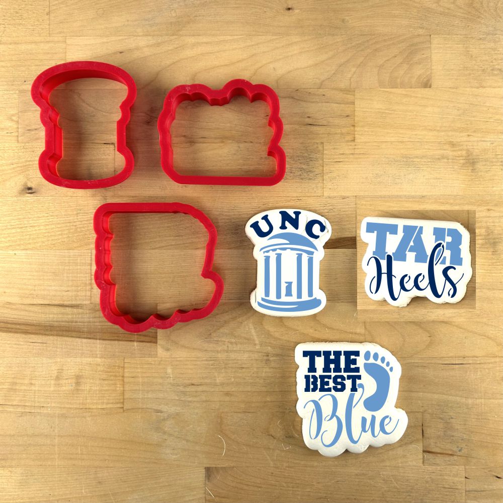 Red cookie cutters and stencils featuring UNC and Tar Heels themes for game-day cookie decorating.