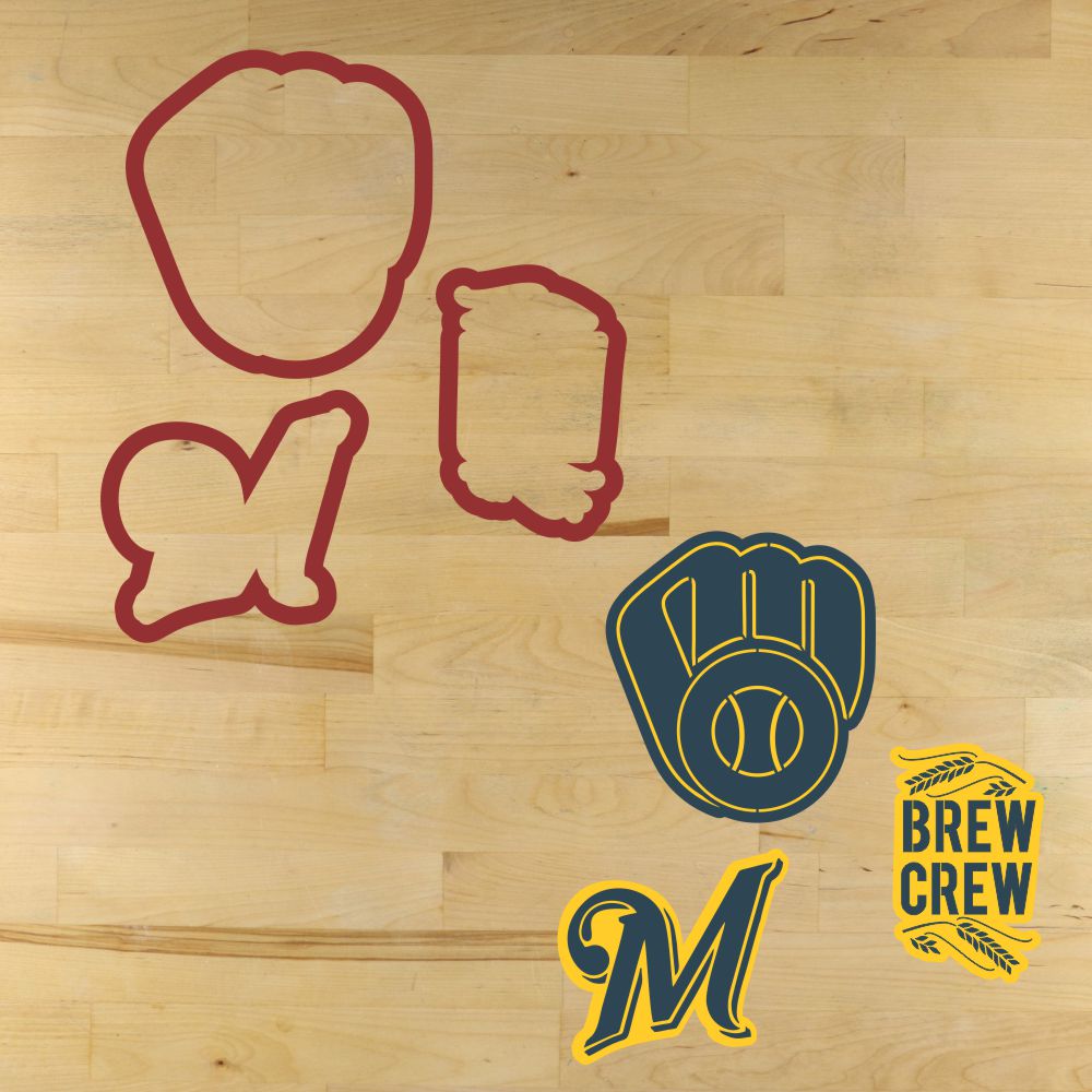 Cookie cutters with brewers-themed designs on a wooden surface, including a glove, helmet, and 'Brew Crew' logo.
