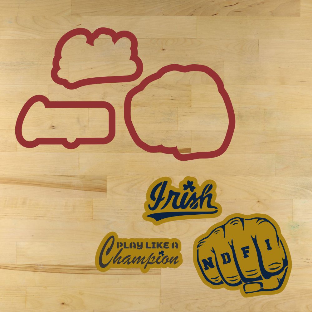Mockup of the Fighting Irish Cookie Cutters and Cookie Stencils laid out on a wooden surface including a fist, helmet, and text.