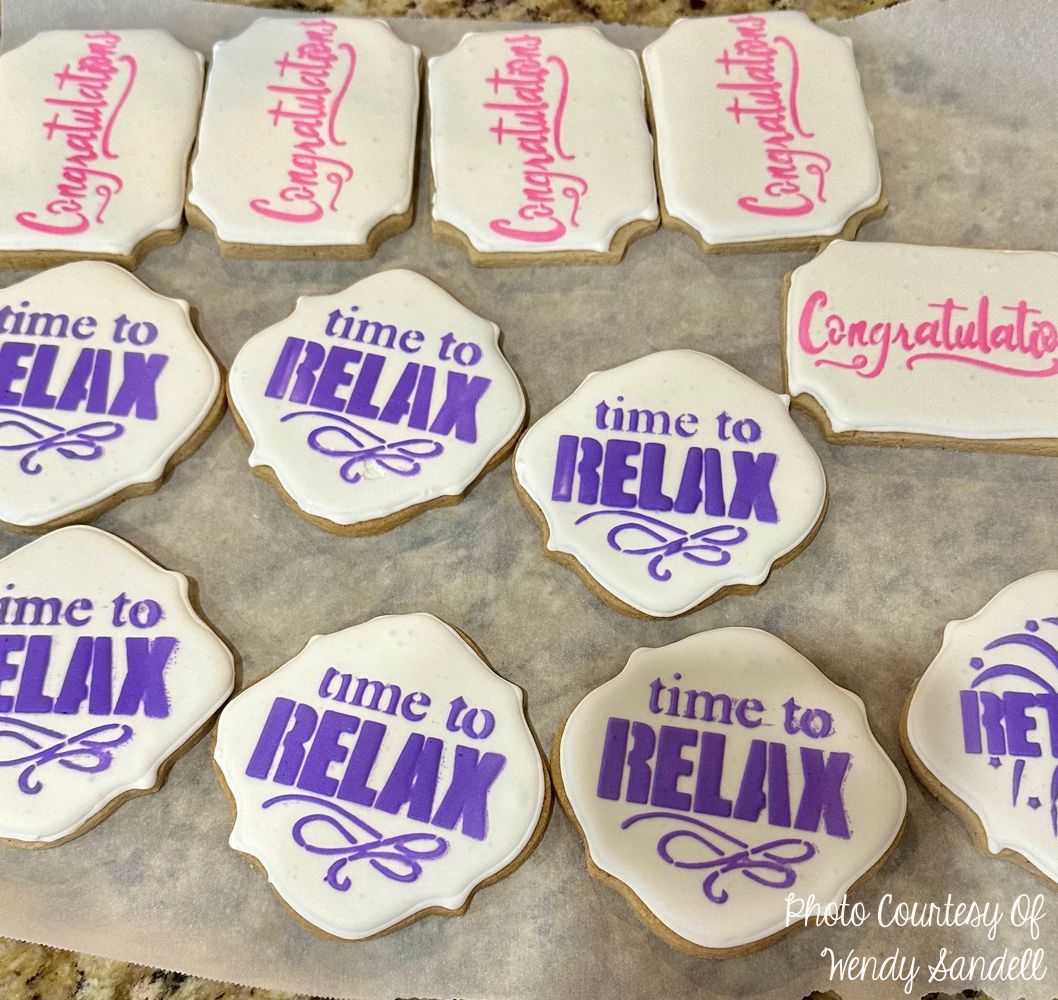 Decorative cookies with messages "time to relax" and "Congratulations" in vibrant colors.