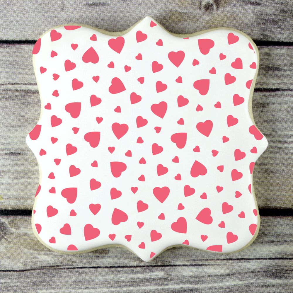 Mini heart-decorated cookie featuring a white background with red hearts, perfect for Valentine's Day treats.
