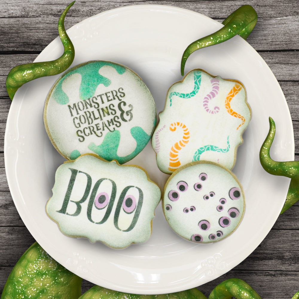 Plate of Halloween cookies airbrushed with Halloween cookie stencils