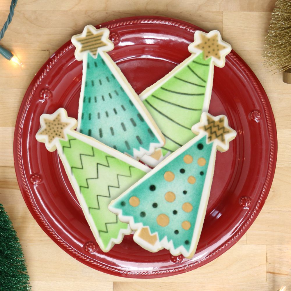 Decorated Christmas tree cookies on a red plate, ideal for holiday baking with cookie stencils.