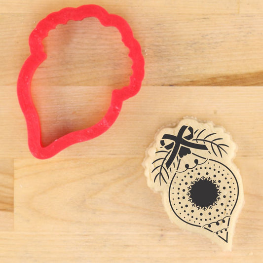Vintage glass ornament cookie cutter and decorated cookie, perfect for holiday baking and crafts using stencils.