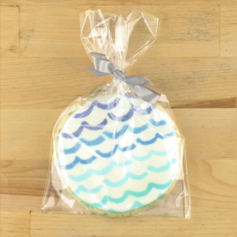 Cookie inside clear cookie bag tied with ribbon