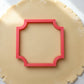 corner plaque cookie cutter being used on sugar cookie dough