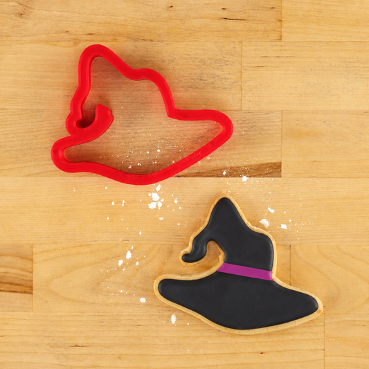Witch Hat Cookie Cutter and a Witch Hat shaped cookie that is iced in black.