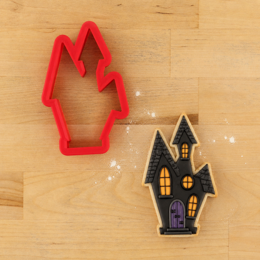 Haunted House Halloween Cookie Cutter with a Haunted House Halloween cookie decorated with black icing windows and doors!