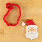 3D Printed Santa Cookie Cutter next to a Santa Face-shaped cookie decorated for Christmas
