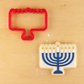 Menorah Cookie Cutter next to a Menorah-shaped cookie decorated for Hanukkah