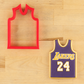 Cookie cutter shaped like a basketball jersey with 'Lakers' and number '24' on a wooden surface