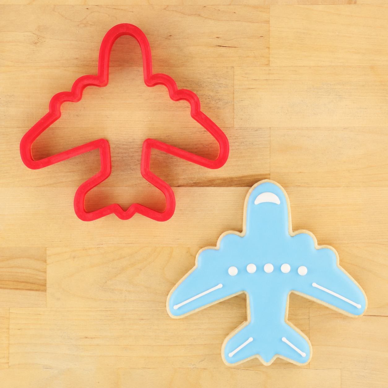 Airplane cutter and airplane shaped cookie for birthday party