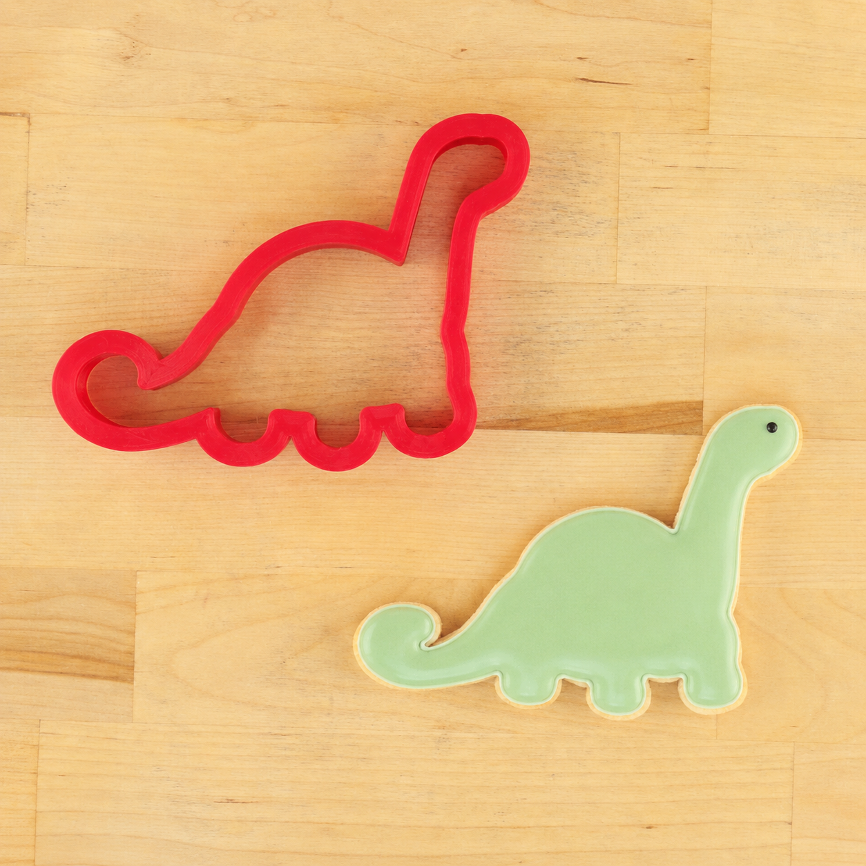 Dinosaur cookie cutter and matching dinosaur-shaped cookie