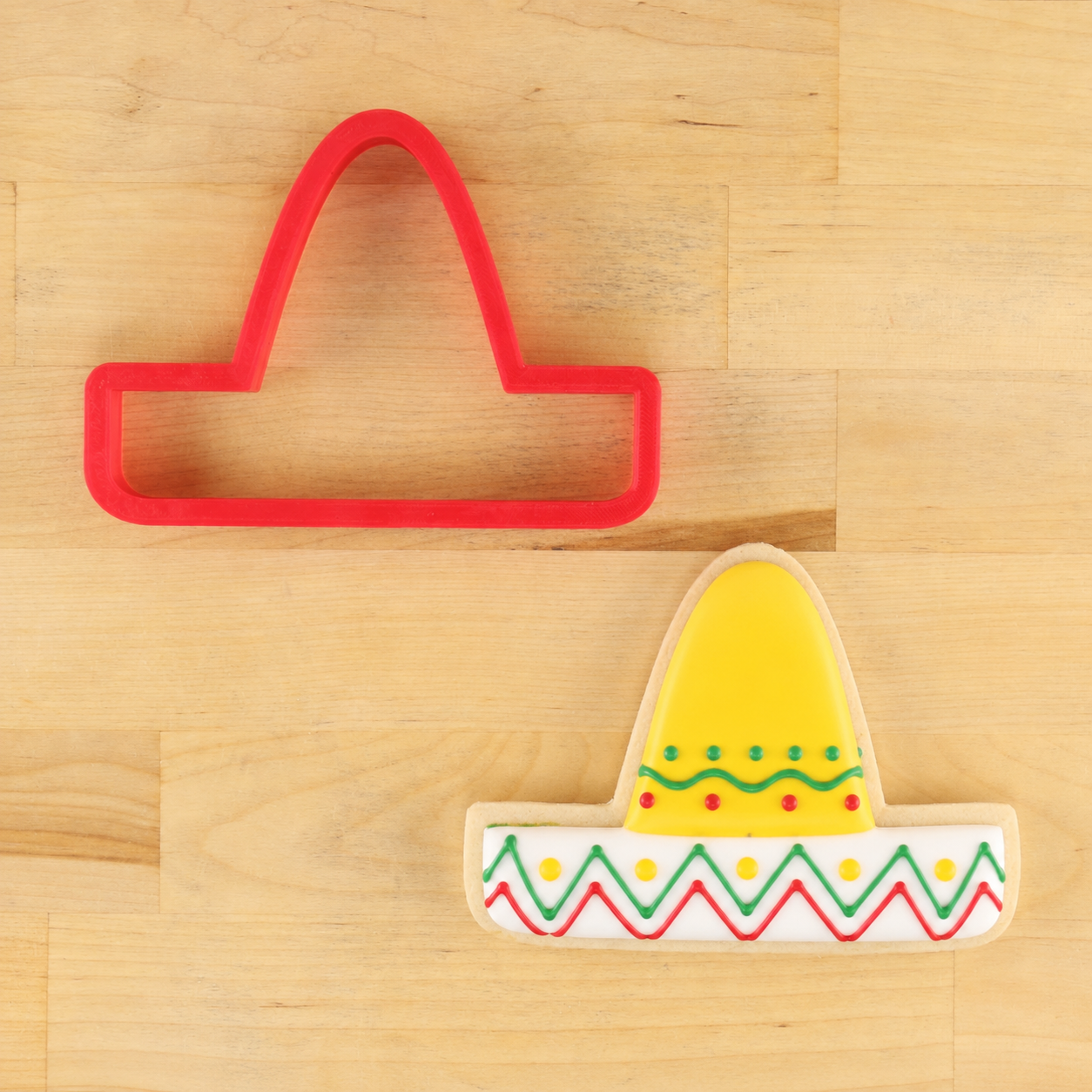 Sombrero cookie cutter and sombrero-shaped cookie decorated for cinco-de-mayo