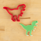 T-Rex cutter next to a t-rex shaped cookie