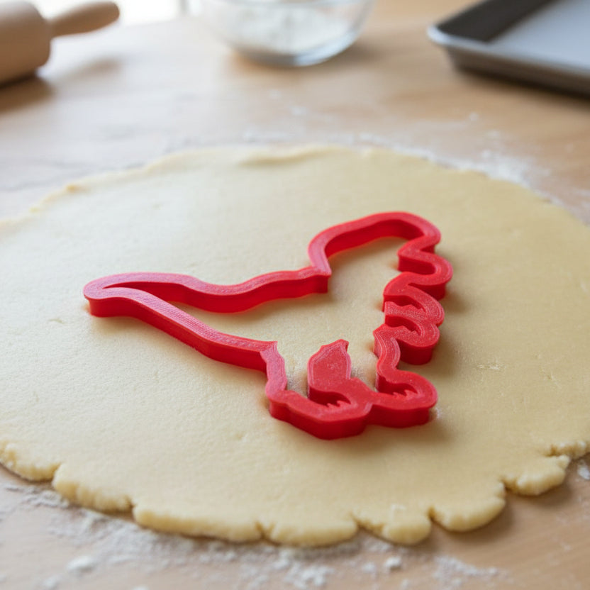 T-Rex Cookie Cutter being used on rolled out cookie dough