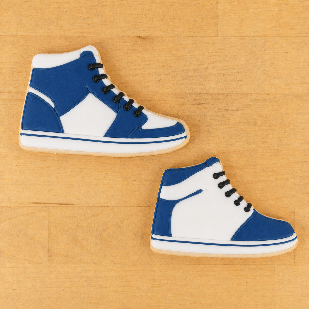Blue and white high-top sneakers on a wooden floor