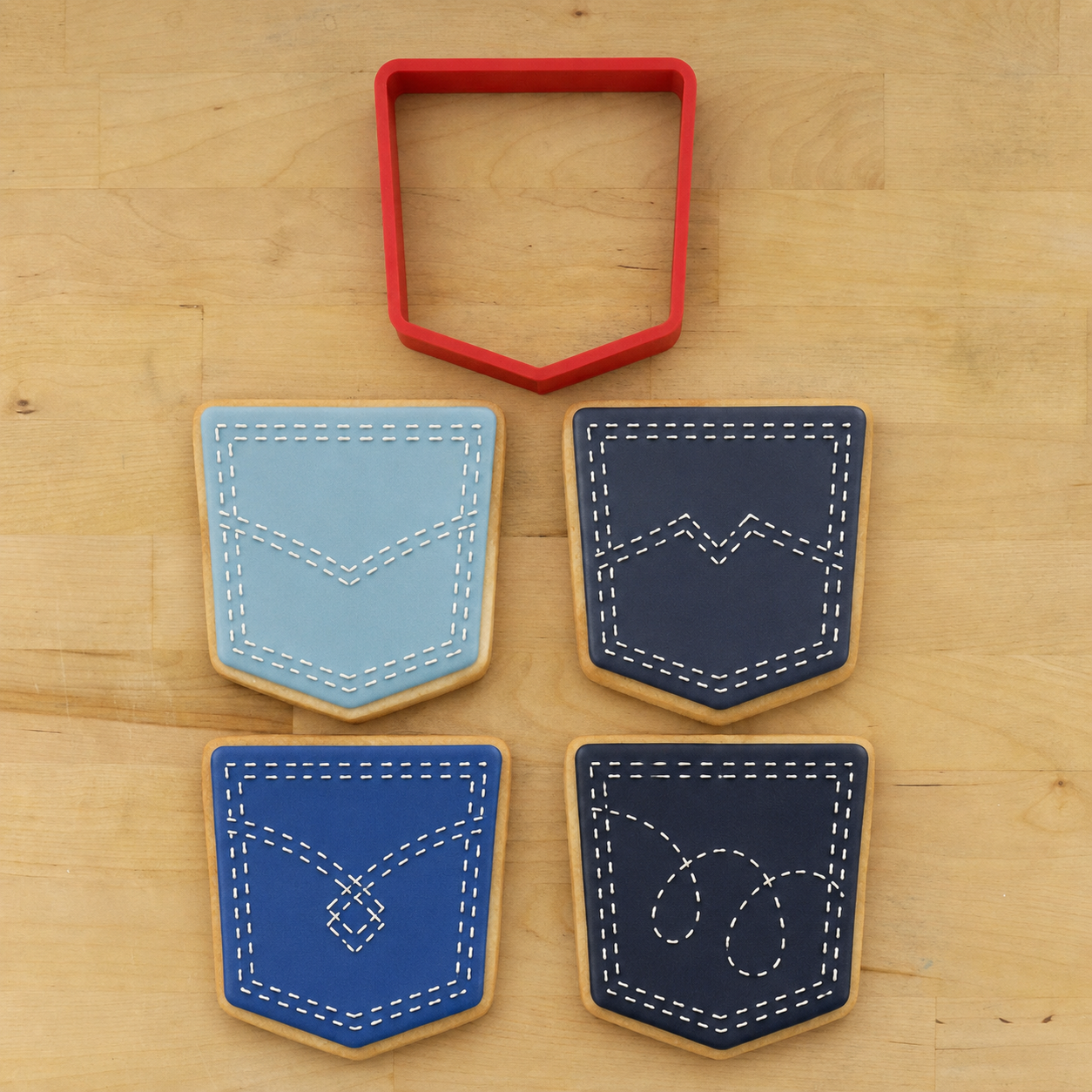 Denim Pocket Cookie Cutter with decorated blue jean pocket cookies featuring classic stitched pocket designs in light and dark denim colors.