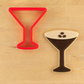 Martini Glass cookie cutter with a matching espresso martini-shaped cookie next to it.