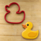 Rubber Duck Cookie Cutter next to a Rubber Duck-shaped cookie iced with yellow icing