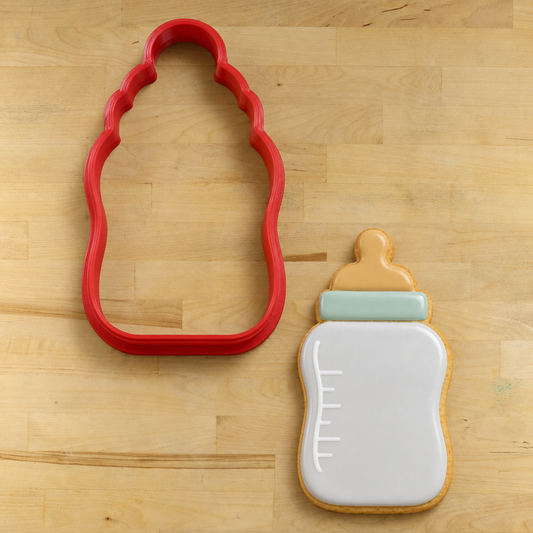 Baby Bottle Cookie Cutter next to a Baby Bottle Cookie decorated for a baby shower