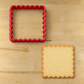 Scalloped Edge Square Cookie Cutter next to a baked, un-decorated cookie in the same shape