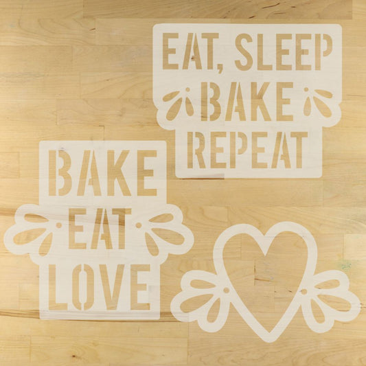 Decorative artisan bread stencils with text and a heart design on a wooden surface