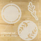 Decorative stencils with leaf patterns and measurements on a wooden surface