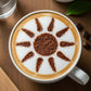 Sun design applied to the top of a coffee drink with cocoa powder