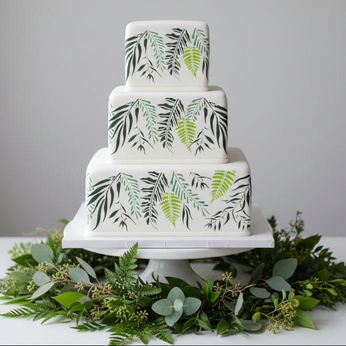 Set of stylized leaf designs in green, gray, and white on a white CAKE