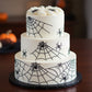 Spider web cake stencil applied to a Halloween cake