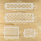 Set of four stencils with geometric patterns and measurements on a wooden surface