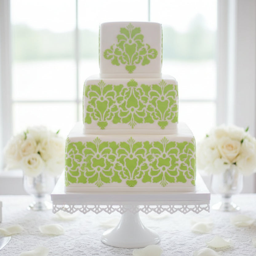 Hillsborough Damask Cake Stencil applied to a square, multi-tiered cake
